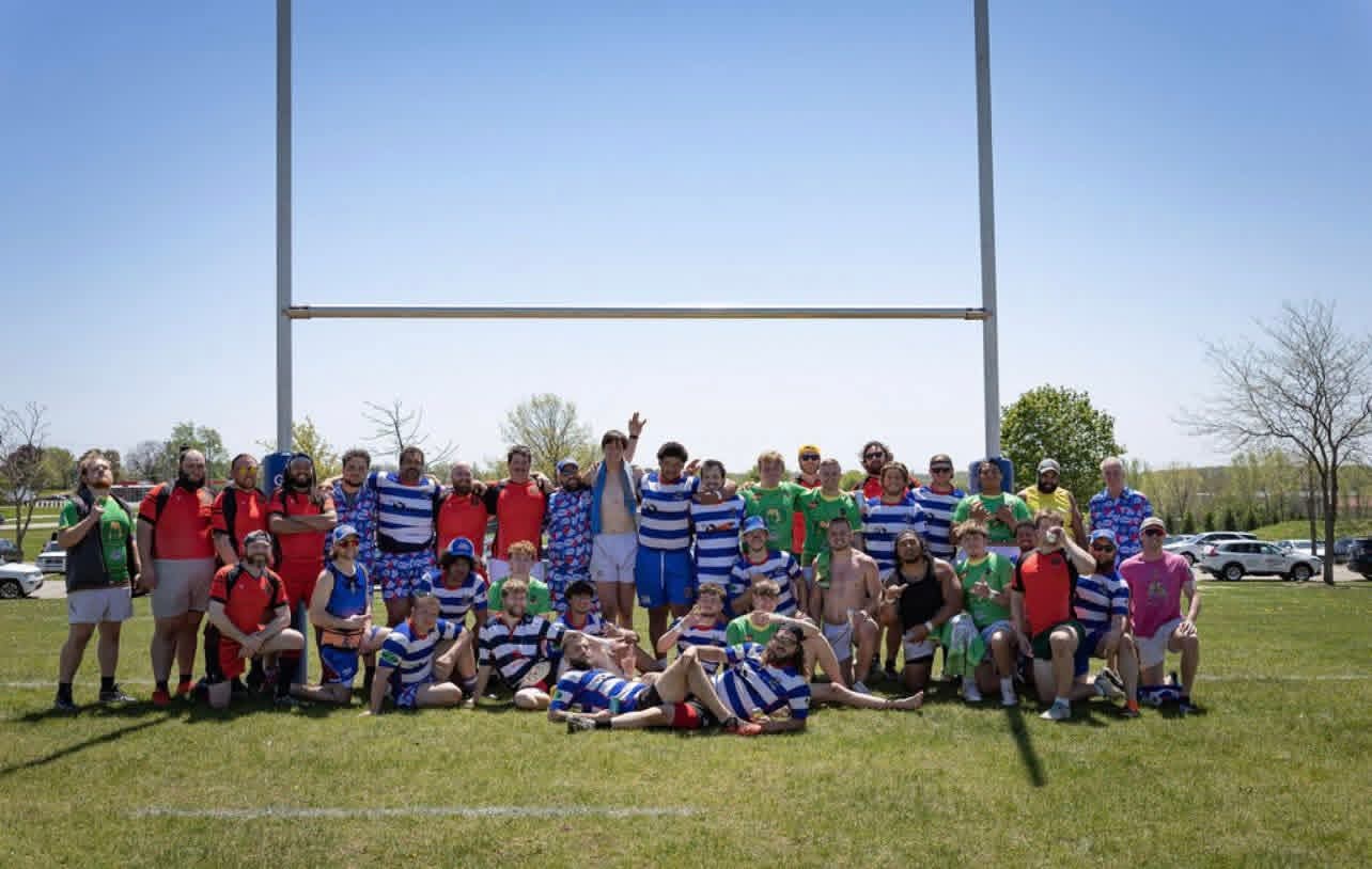 Full Berserkers squad and opposing club posing under the rugby posts