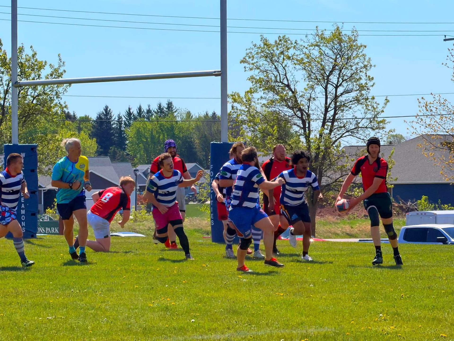 Berserkers player with ball in hand attacking near the posts against a striped side