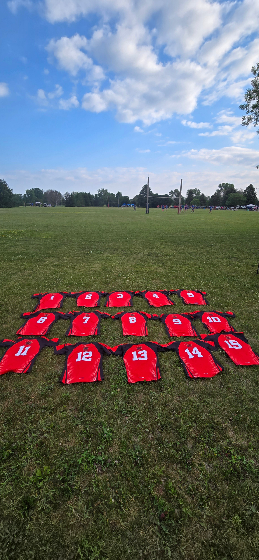 Berserkers match jerseys numbered 1 to 15 laid out on the grass before kickoff