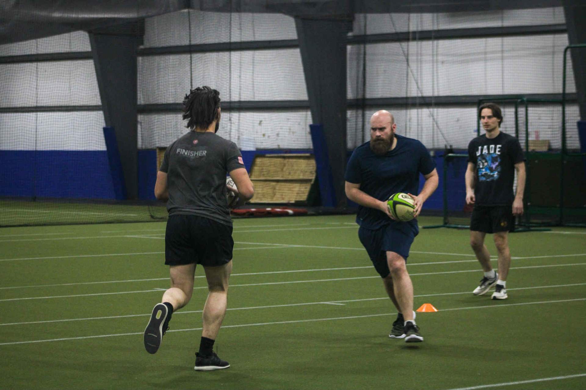 Escanaba Berserkers Rugby Football Club players practicing passing drills indoors in Escanaba, Michigan